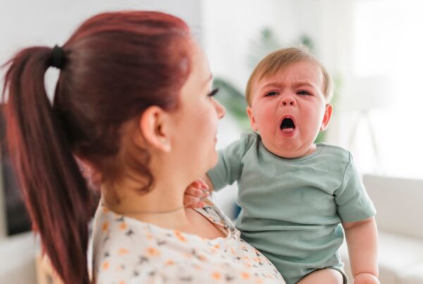 Mother holding little boy who is coughing